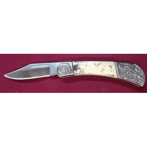 118 - American pocket knife with clip blade and ornate handle, comprising of two piece bone grip and engra... 