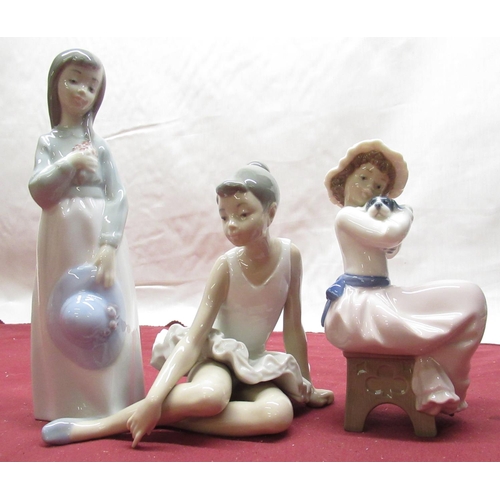 117 - Nao figure of a young girl in mop cap holding a puppy H17cm, Nao figure of a seated female ballerina... 