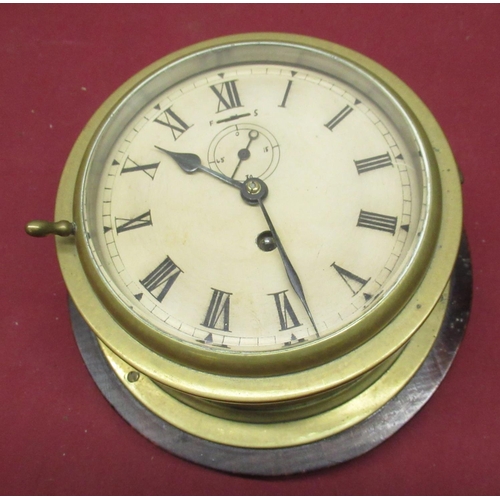 120 - C20th brass cased bulk head ships time piece, hinged bezel enclosing cream painted dial with Roman n... 