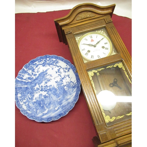 143 - Victorian style oak cased chiming wall clock and 20th C Chinese blue and white charger with crimped ... 