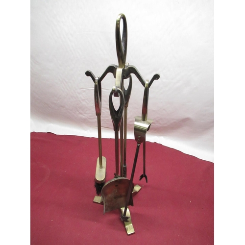 177 - Four piece lacquered brass companion set on stand