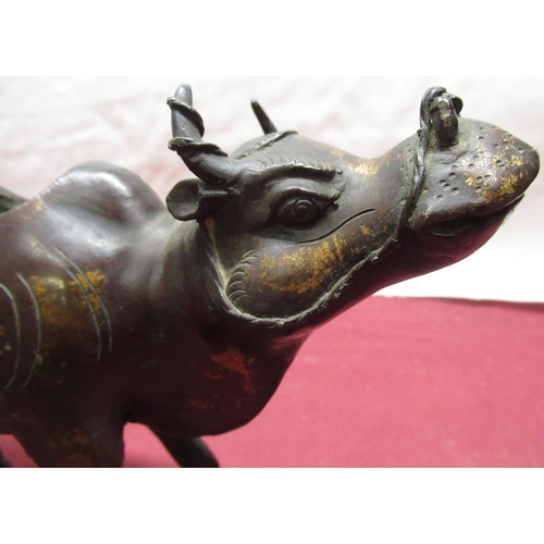 257 - Early C20th bronze figure of a water buffalo with traces of gilt detail H14cm, C20th cast bronze Bud... 