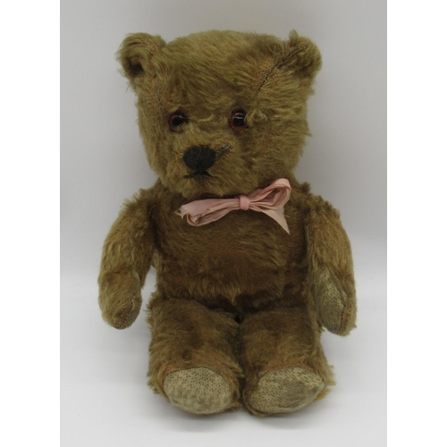 43 - Chiltern c. 1930's teddy bear with glass eyes, jointed arms and legs and swivel head, wearing beige ... 
