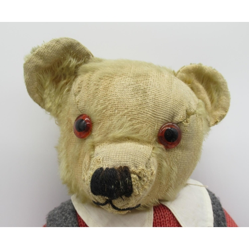 78 - Circa 1930s Merrythought teddy bear with glass eyes, jointed arms and legs and a swivel head wearing... 