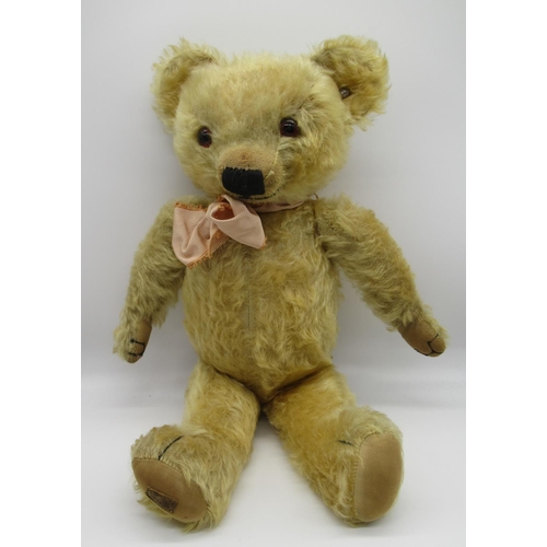 79 - Circa 1930s Merrythought teddy bear in golden mohair with tag on foot, button in ear, glass eyes, jo... 