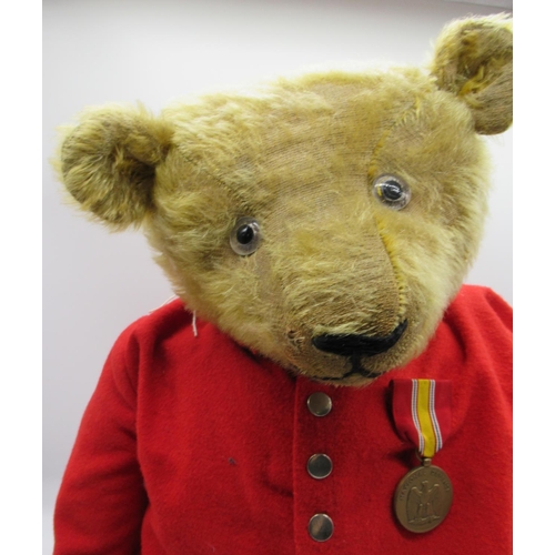 135 - Early C20th large American teddy bear in blonde mohair with clear glass eyes, non-working growler me... 