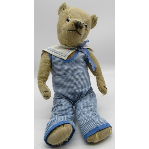 71 - Merrythought c. 1930's teddy bear dressed in original tennis outfit and cap, with glass eyes, button... 