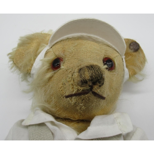 71 - Merrythought c. 1930's teddy bear dressed in original tennis outfit and cap, with glass eyes, button... 