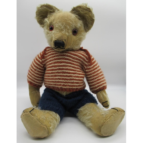 38 - Merrythought c. 1930's teddy bear with glass eyes, jointed arms and legs and swivel head, wearing kn... 