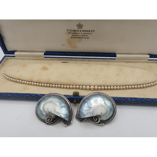 29 - Graduated simulated pearl necklace with a Sterling silver fish hook clasp decorated with three marqu... 