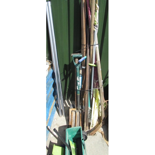 71 - Large quantity of garden tools including spades, forks, rakes, pick axe, copper piping etc