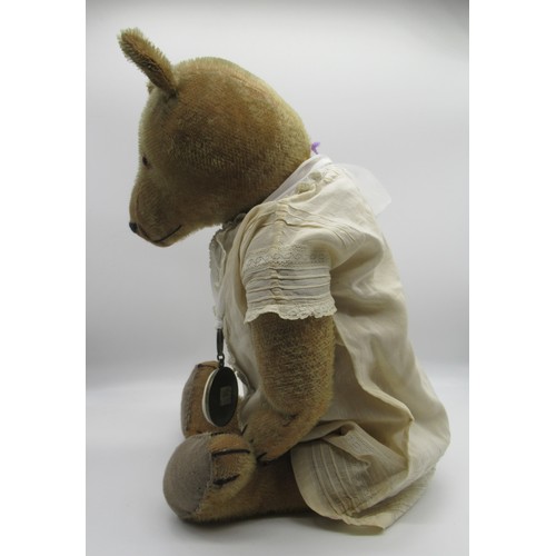 148 - Early American teddy bear with glass eyes and non-working growler mechanism, wearing a white dress a... 