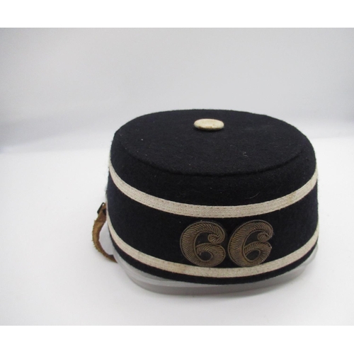 821 - Military regimental pill box hat embroidered with number 66, complete with badge to the front and le... 