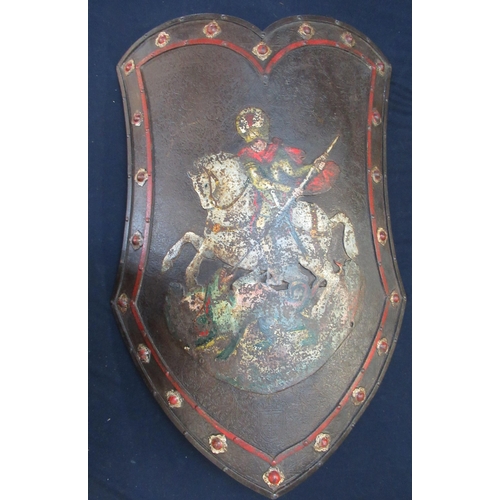 784 - C18th iron shield embossed with painted figure of St George and the dragon with bossed detail to the... 