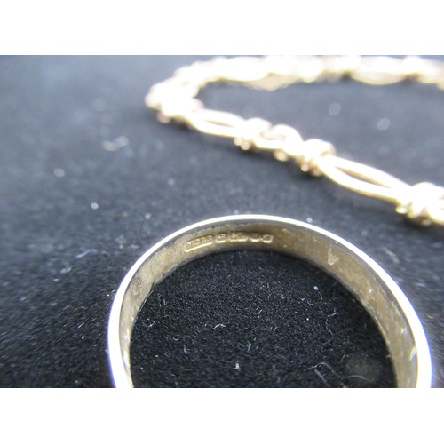 10 - 9ct gold chain bracelet with safety chain stamped 9K and a hallmarked 9ct gold wedding band Size M 1... 