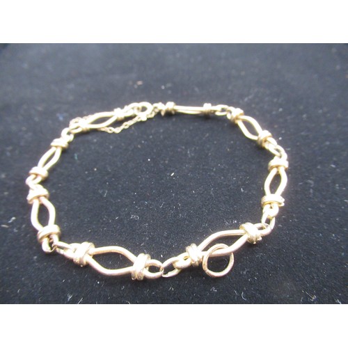 10 - 9ct gold chain bracelet with safety chain stamped 9K and a hallmarked 9ct gold wedding band Size M 1... 