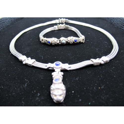 11 - Silver woven chain necklace with lion pendant inset with blue hardstone and box clasp stamped 925 an... 