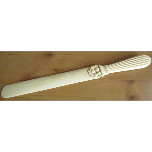 49 - Victorian carved ivory paper knife, with reeded shaped handle and floral and leaf carved mount L30cm