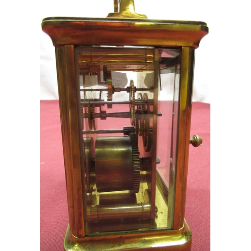 129 - Late C19th French brass gorge cased carriage time piece with beveled glass panels, later replacement... 