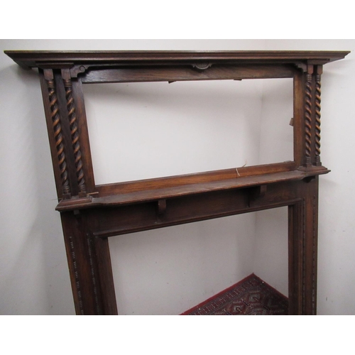 423 - 1930's oak fire surround with moulded cornice, octagonal mirror with twin barley twist supports, and... 