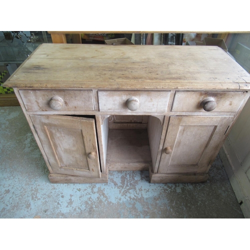 392 - Victorian pine knee hole desk with three drawers above two panel doors and a recess on plinth base W... 