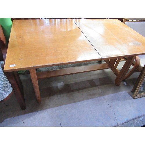 431 - Oak extending dining table, on pierced end supports joined by a stretcher and four oak dining chairs... 