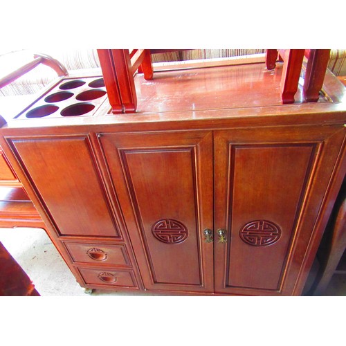 376 - Chinese style hardwood drinks trolley with two carved panel doors two short drawers