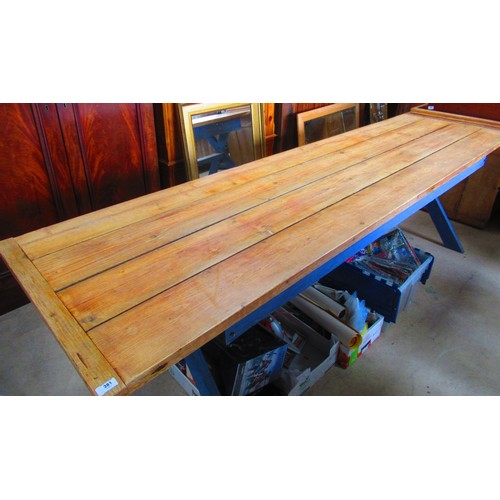 381 - Large pine dining table with planked top on painted blue cross supports joined by stretcher L275cm W... 