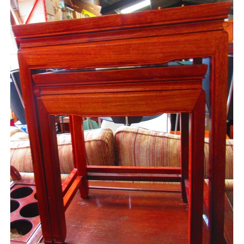 518 - Nest of two hardwood Chinese style tables on carved supports