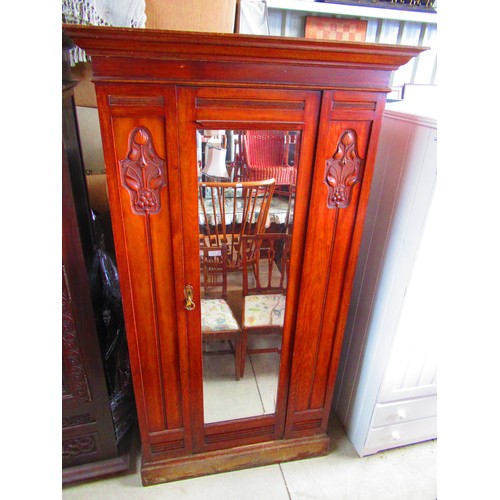 516 - Victorian walnut wardrobe with single mirror door and floral carved panels on a plinth base W113cm D... 