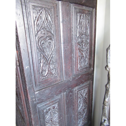 2303 - Antique oak wardrobe, dentil moulded cornice above pair of doors, each with arched figural and Gothi... 
