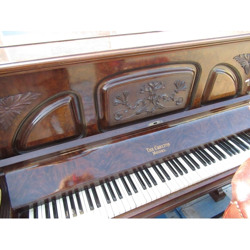 506 - Walnut cased upright piano marked the Carlton model