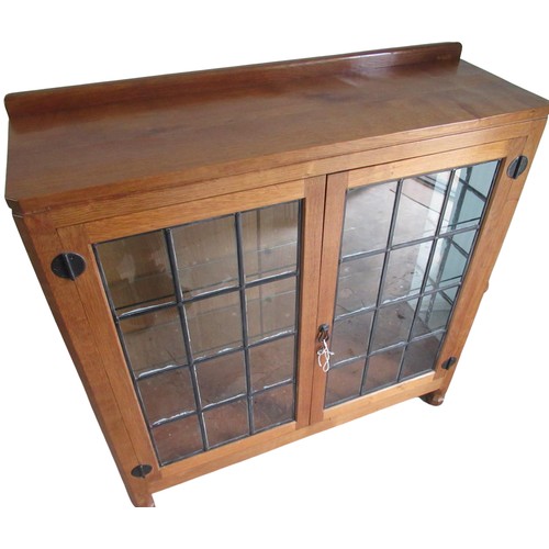 2009 - Robert Mouseman Thompson - an oak display cabinet, low raised back with adzed top above a pair of le... 