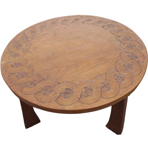 2068 - Thomas Gnomeman Whittaker - oak coffee table, circular top carved with strapwork on three angular cu... 