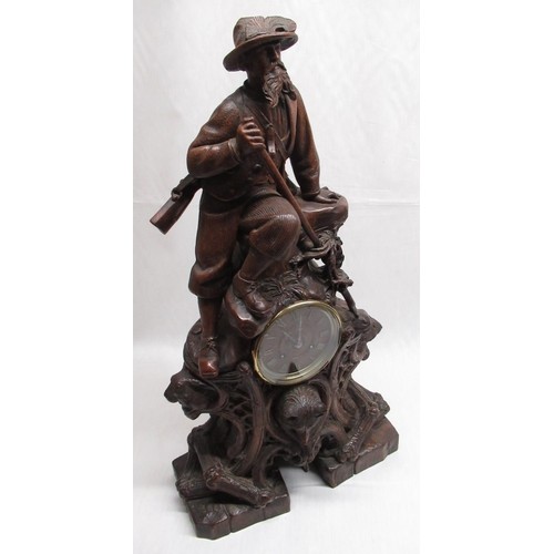 2137 - C19th Black Forest figural clock, carved with a Alpine Hunter, and game in scroll mount on stonework... 
