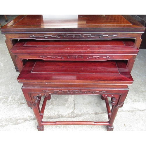 2302 - Nest of three Chinese padouk wood rectangular tables, blind fret friezes on square shaped supports, ... 