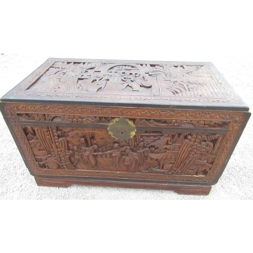 2352 - C20th Chinese camphor lined blanket box, hinged top and front with deep carved with figures in a gar... 