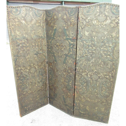 2353 - Early C20th two fold screen, the three arched panels with brass nailed embossed and painted decorati... 