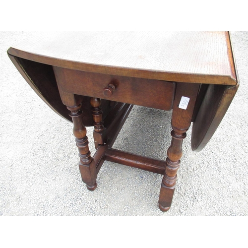 2357 - Titchmarsh & Goodwin oak gate leg dining table with two D shaped leaves and end drawer on baluster t... 