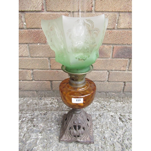 235 - Edwardian oil lamp, art nauveau cast metal base, amber reservoir and green tint shade