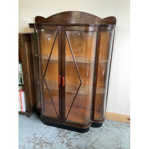 129 - C. 1920's/30's bow front china cabinet enclosed by pair of plastic glazed door with plastic internal... 
