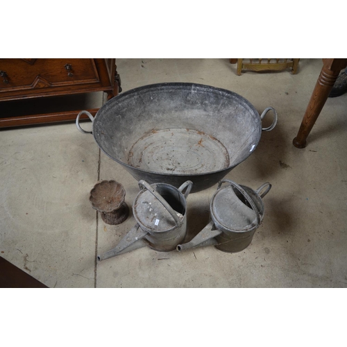 196 - Galvanized twin handled tub, cast metal bird bath and two galvanized watering cans