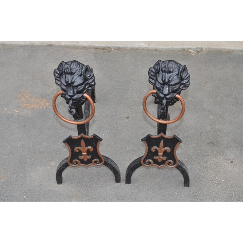 197 - Pair of cast metal lion head and shield fire dogs