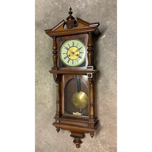 228 - Victorian walnut cased Vienna type wall clock, cream Roman dial enclosed by hinged glazed door, abov... 