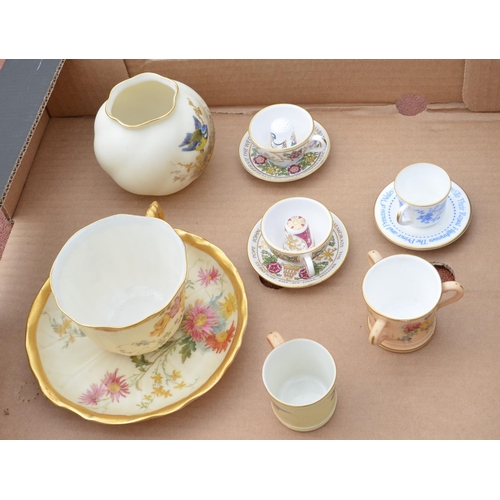 491 - Royal Worcester cup and saucer decorated with spring flowers on a blush ivory ground with gilt borde... 