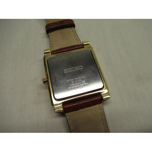 40 - Seiko quartz wristwatch with day, date and 24 hour indicator. Rectangular gold-plated case on origin... 
