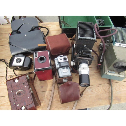 71 - Selection of various cameras including a red leather covered Kodak portrait brownie no. 2, brown mar... 