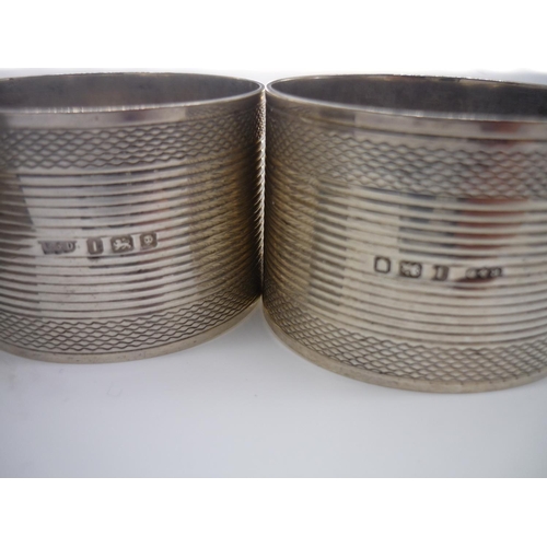 5 - Pair of Geo.VI hallmarked engine turned silver napkin rings, Birmingham 1928, boxed and a similar pa... 