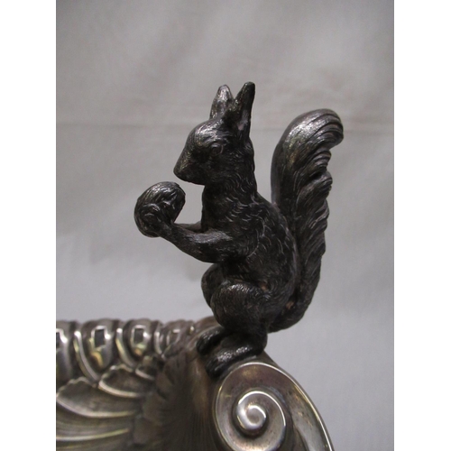137 - Silver plated shell shaped nut bowl, with decorative scroll shaped squirrel handle. H22cm L26cm