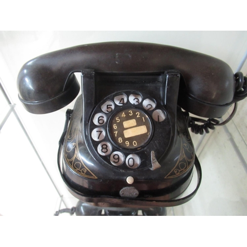 75 - Mid 1950s Bell Telephone Company telephone with painted black alloy body and gilt highlights and Bak... 